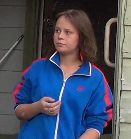 Image of Katrina standing outside of house