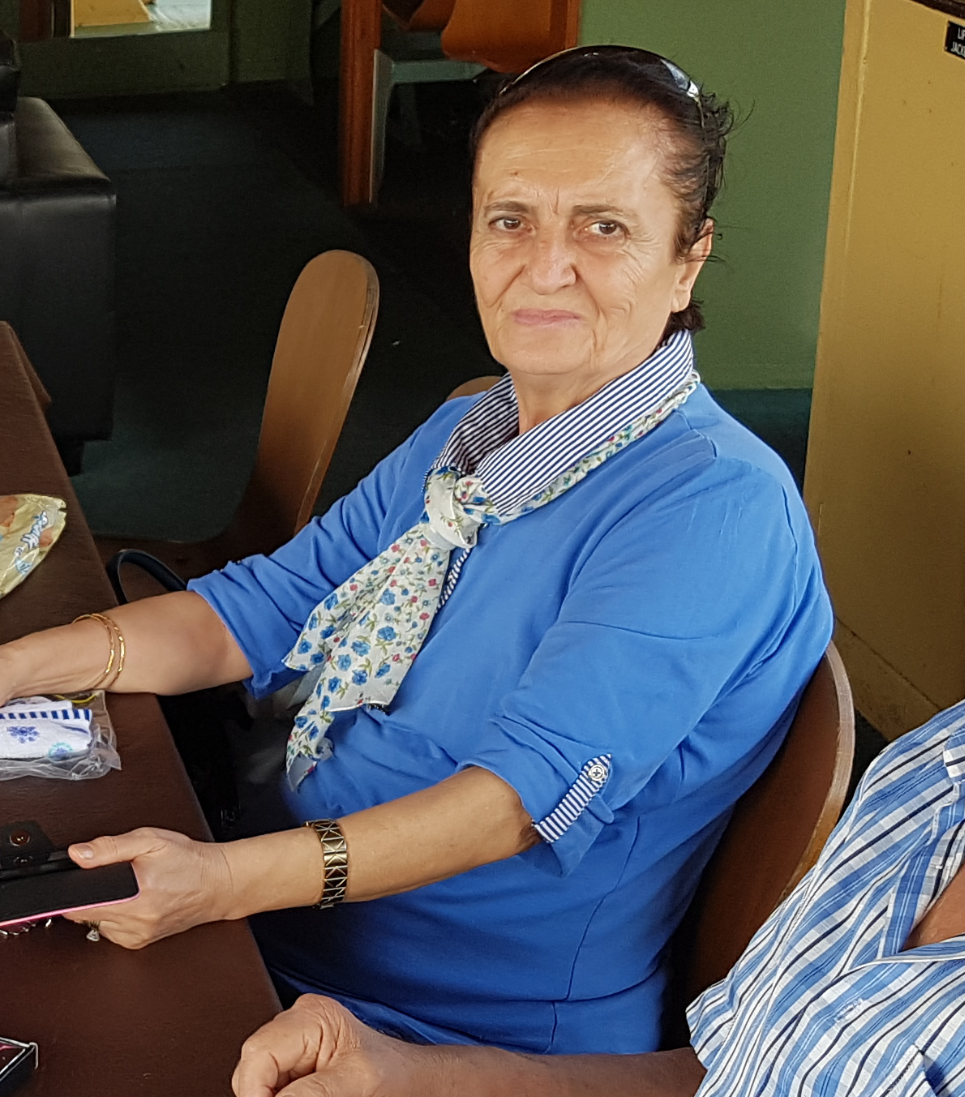 Ms Nadire Sensoy sitting at table 